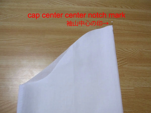 Marking the cap center of the sleeve with a pin before attaching it to the armhole