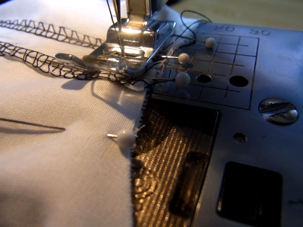 Detailed view of attaching sleeves to the armhole with pins in place