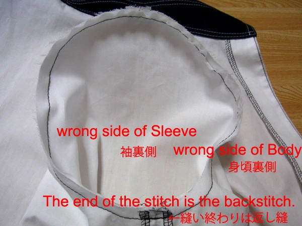 Sewing the sleeve to the armhole with a final backstitch