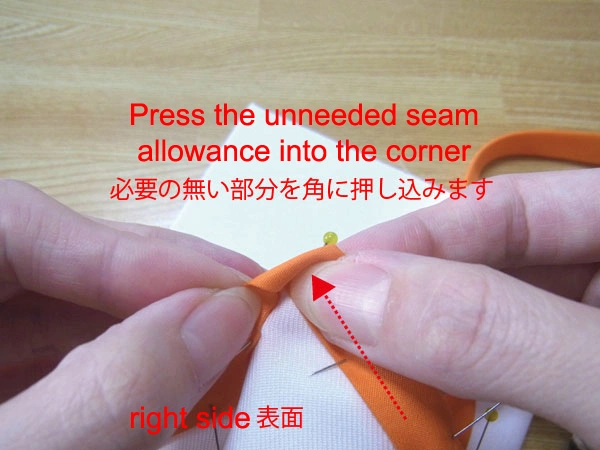 Press the unnecessary seam allowance into the corner