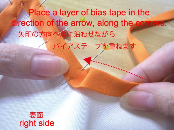 Layer bias tape toward the arrow with a little slack