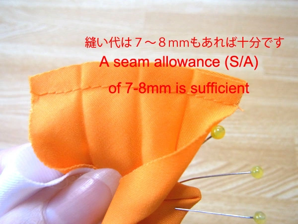 Cutting off excess seam allowance after sewing bias tape