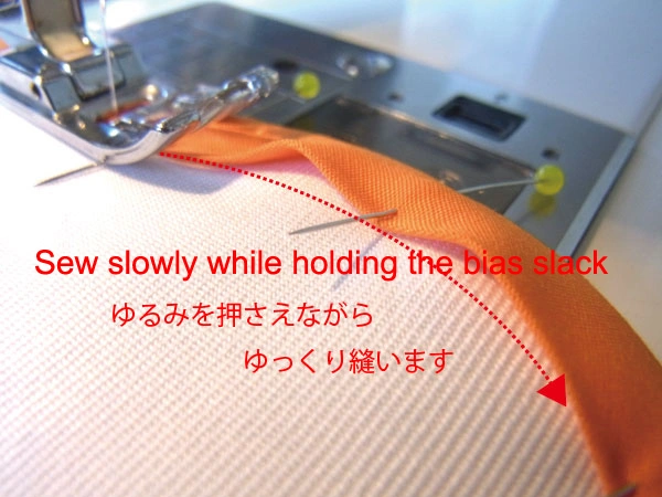 Holding down loose bias tape on a bulging curve