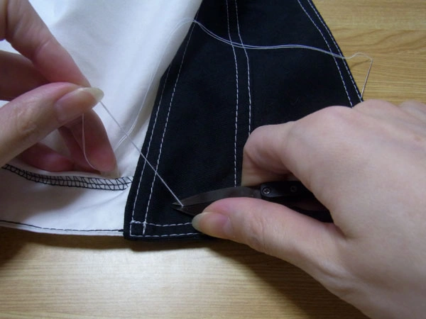 Cutting thread after finishing button sewing