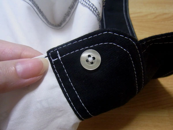 Button floating slightly from fabric side view