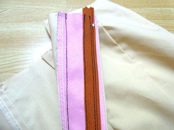 Facing and extension parts sewn in place