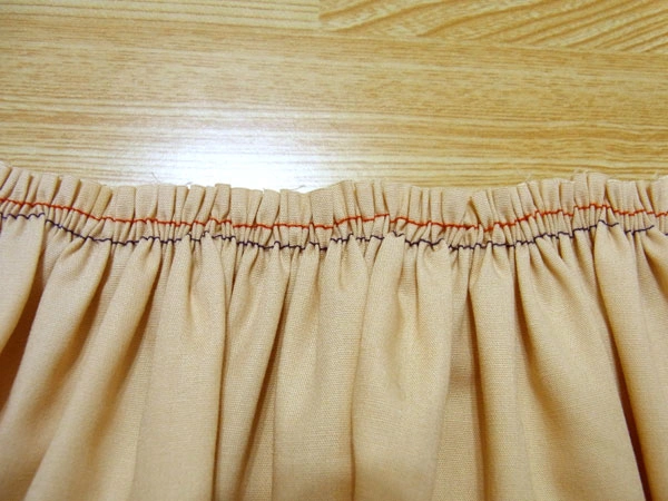 Lightly ironing gathered fabric to keep it flat