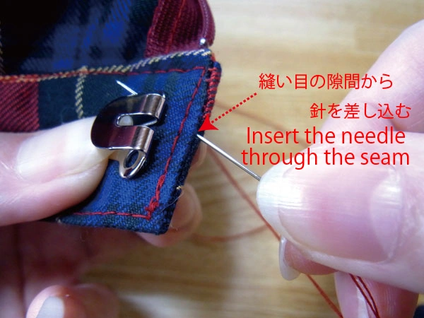 Inserting needle to hide knot inside fabric
