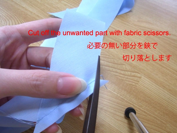 Cutting off unnecessary fabric with scissors